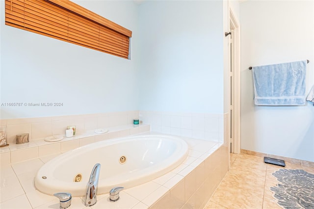 bathroom with tile patterned floors and tiled tub