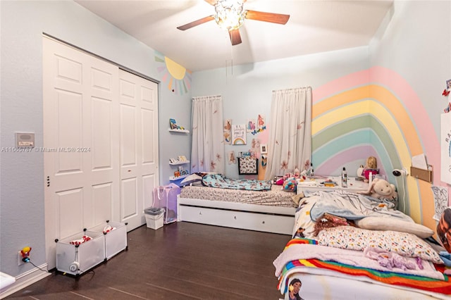 bedroom with dark hardwood / wood-style flooring, a closet, and ceiling fan