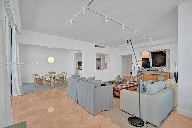 living room featuring light tile patterned flooring and track lighting