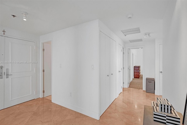 corridor with light tile patterned floors