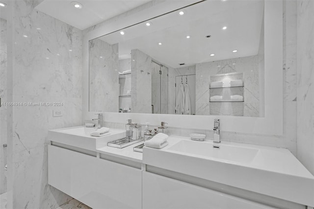 bathroom featuring a shower and vanity