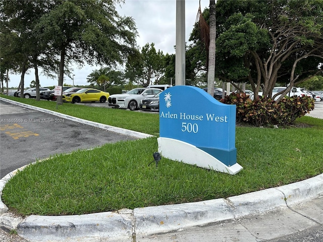 community sign featuring a lawn