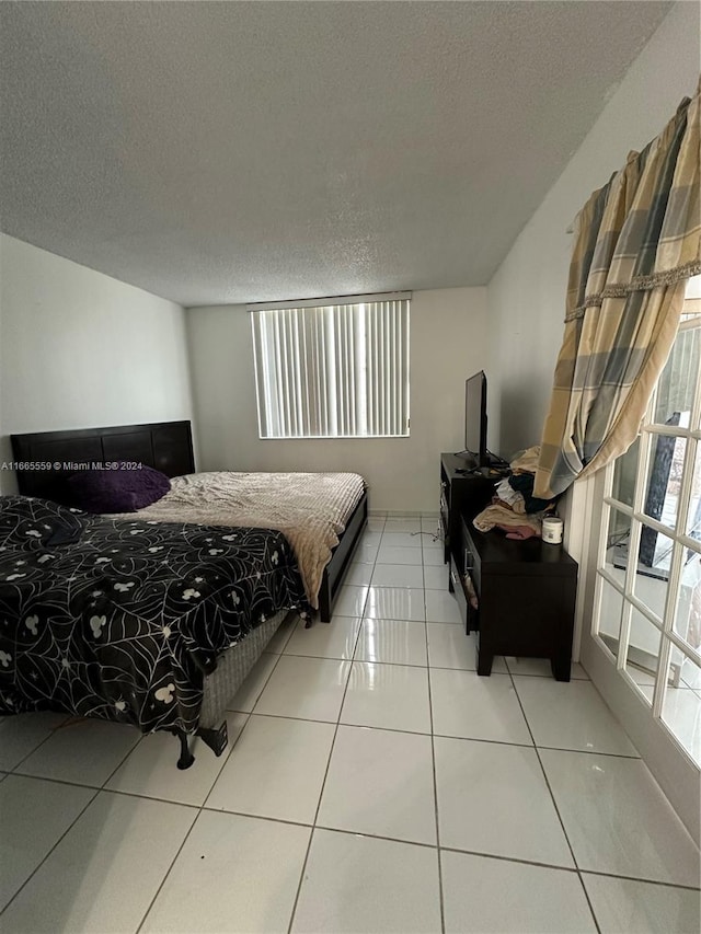 tiled bedroom with a textured ceiling