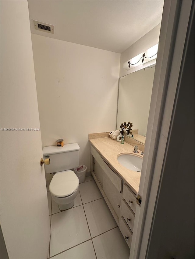 bathroom featuring vanity, toilet, and tile patterned flooring