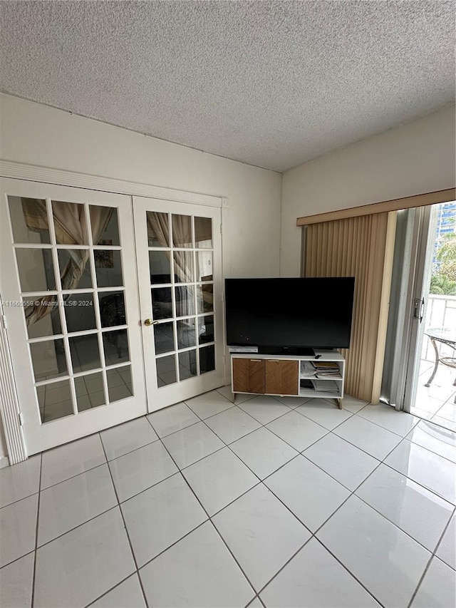 unfurnished living room with tile patterned floors and a textured ceiling