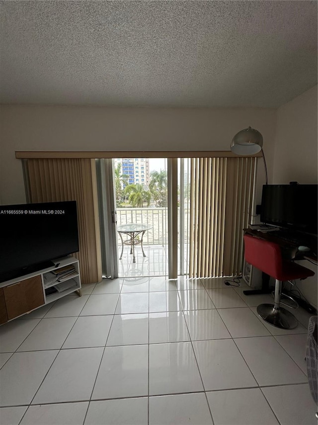 tiled living room featuring a textured ceiling