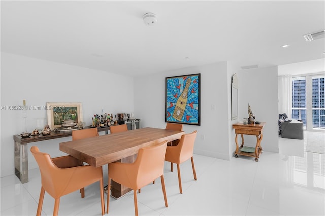 dining space featuring light tile patterned flooring