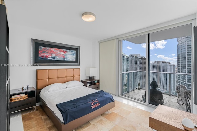 bedroom with floor to ceiling windows and access to outside