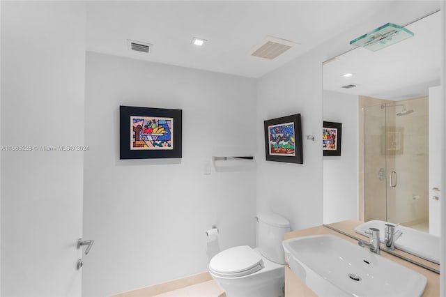 bathroom featuring sink, tile patterned flooring, walk in shower, and toilet