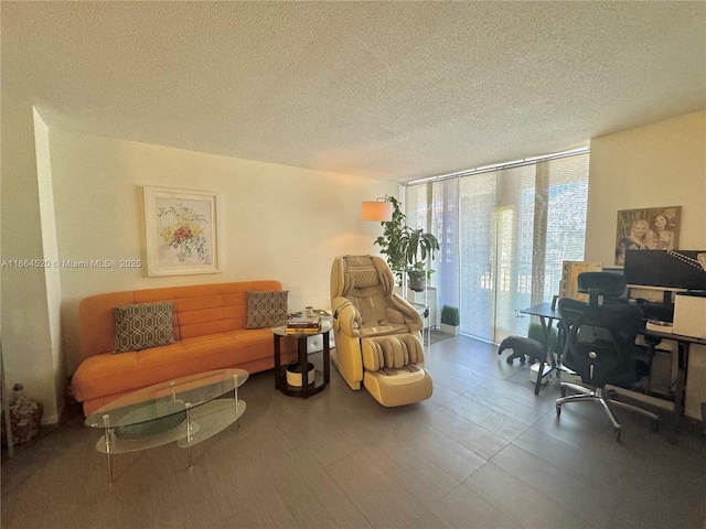 living area with floor to ceiling windows and a textured ceiling