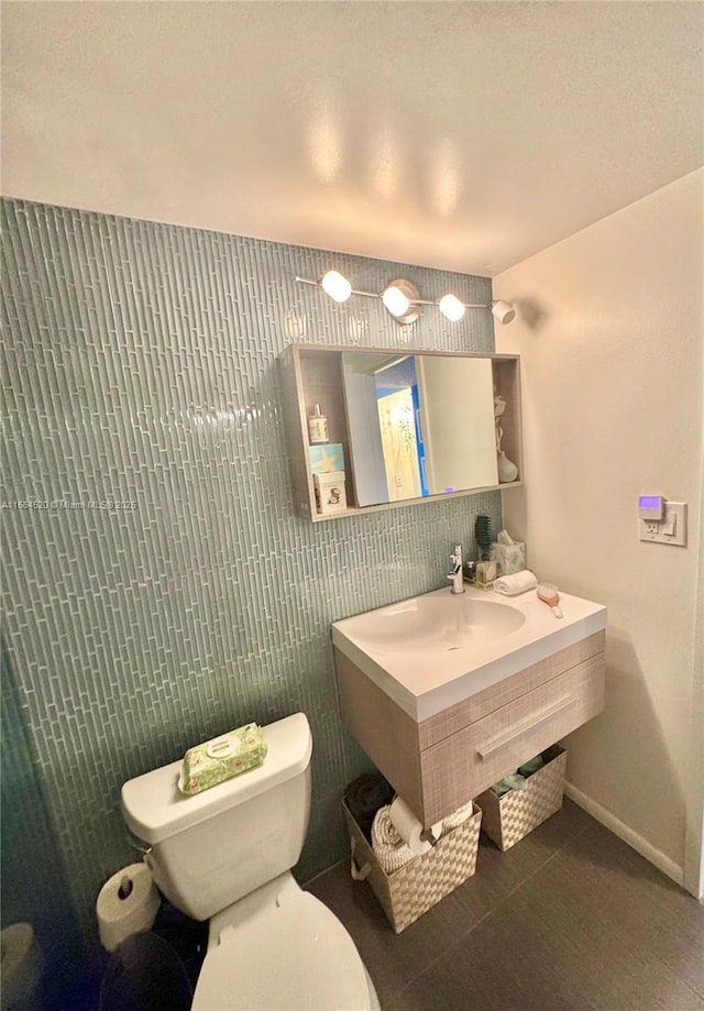 bathroom featuring tile patterned floors, toilet, and vanity