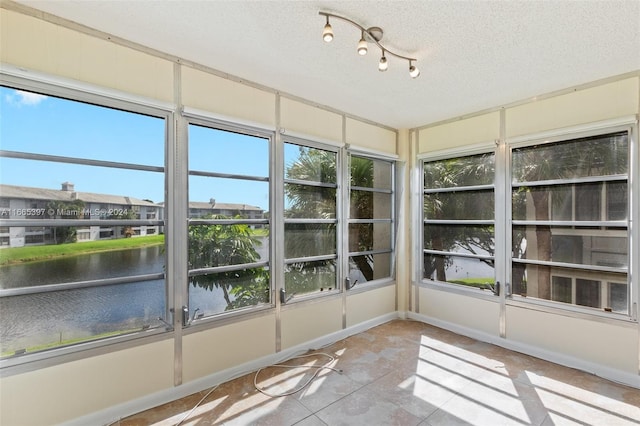 unfurnished sunroom with a water view and plenty of natural light