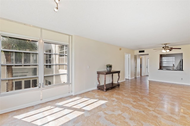 spare room with sink and ceiling fan