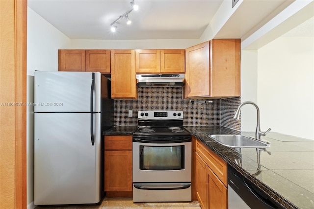 kitchen with appliances with stainless steel finishes, backsplash, and sink