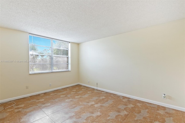 empty room with a textured ceiling