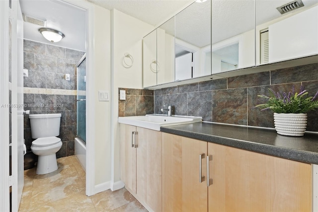 full bathroom featuring enclosed tub / shower combo, vanity, a textured ceiling, toilet, and decorative backsplash