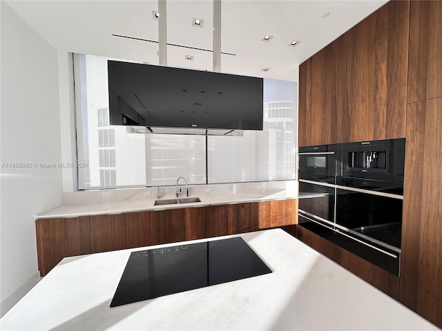 kitchen featuring sink and black appliances