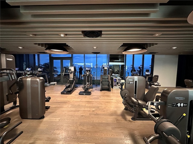 exercise room featuring hardwood / wood-style floors and a wall of windows