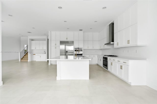8095 Crystal Downs Ave, Boca Raton, FL 33434 - kitchen with stainless steel appliances, wall chimney range hood, a center island with sink, and light countertops