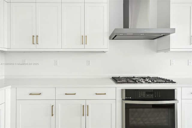 8095 Crystal Downs Ave, Boca Raton, FL 33434 - kitchen with wall chimney exhaust hood, stainless steel appliances, light countertops, and white cabinetry
