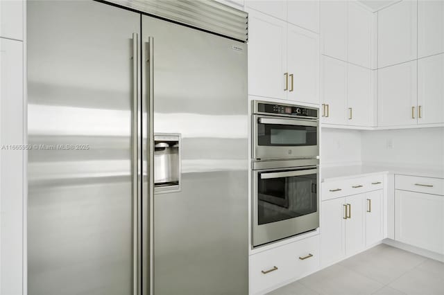 8095 Crystal Downs Ave, Boca Raton, FL 33434 - kitchen with stainless steel appliances, light countertops, white cabinets, and light tile patterned floors