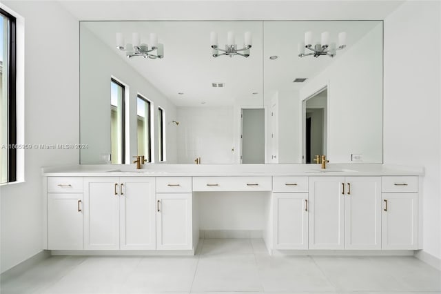 bathroom with tile patterned floors, a shower, and vanity