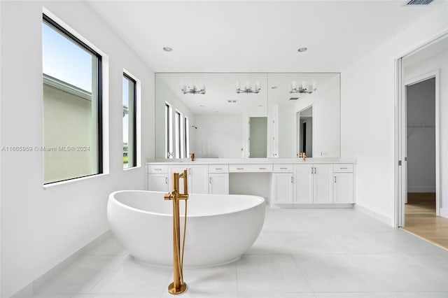 bathroom with tile patterned floors, independent shower and bath, and vanity