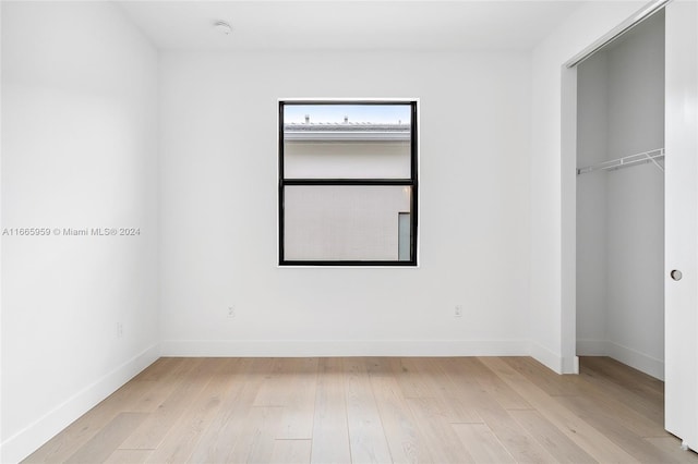 unfurnished bedroom with light wood-type flooring