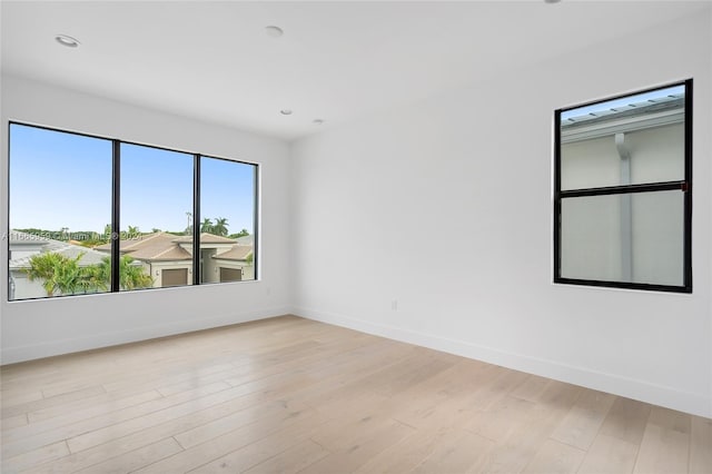 spare room with light hardwood / wood-style flooring