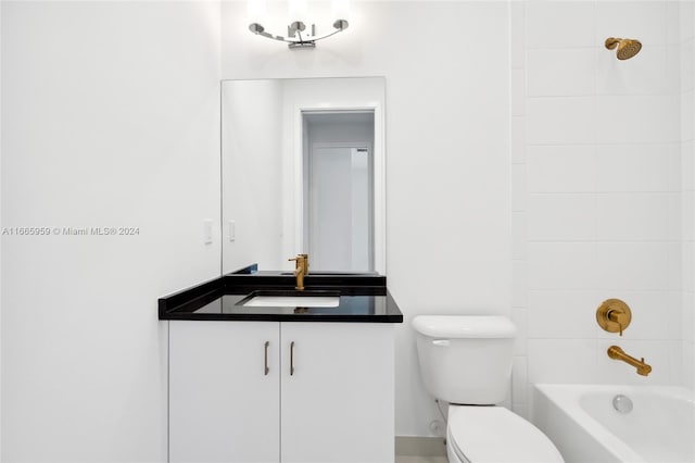 full bathroom featuring tiled shower / bath combo, vanity, and toilet