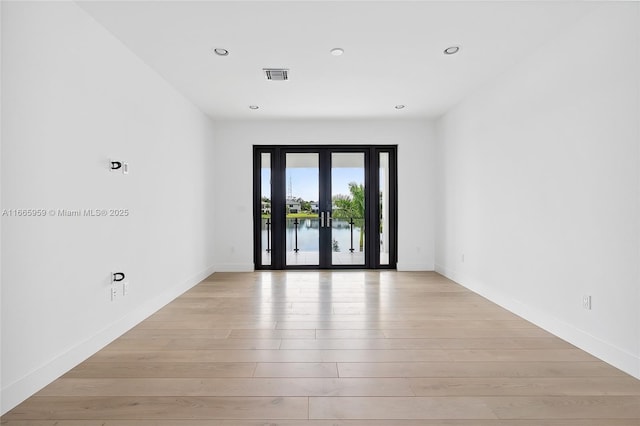 8095 Crystal Downs Ave, Boca Raton, FL 33434 - empty room with light wood-style flooring, recessed lighting, and french doors