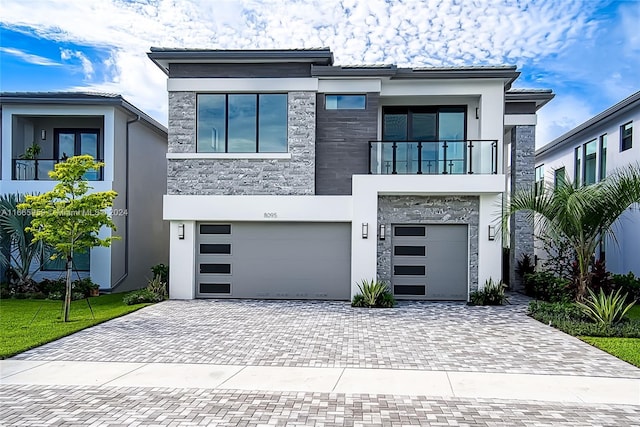 modern home featuring a balcony and a garage