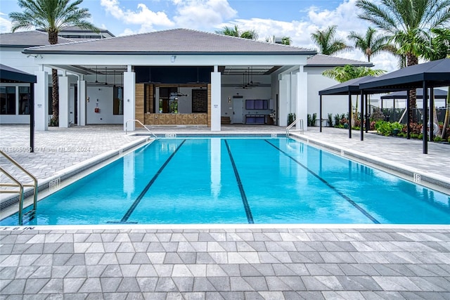 view of swimming pool with a patio, ceiling fan, and a gazebo