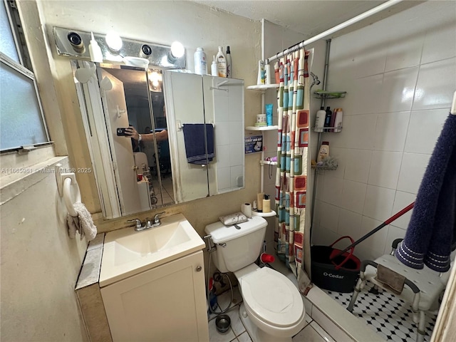 bathroom with tile patterned floors, vanity, toilet, and walk in shower