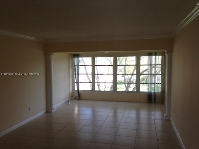 6001 NW 61st Ave Unit 308, Tamarac, FL 33319 - spare room featuring ornamental molding, plenty of natural light, tile patterned flooring, and ornate columns