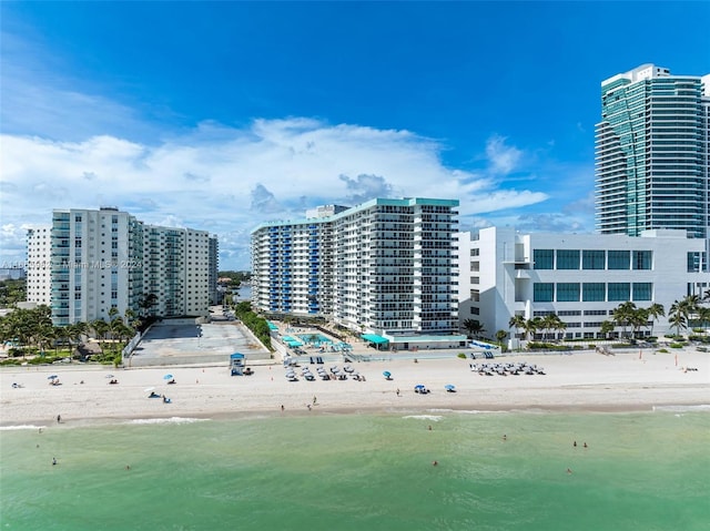 bird's eye view featuring a water view and a beach view