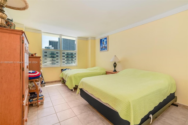 tiled bedroom featuring ornamental molding