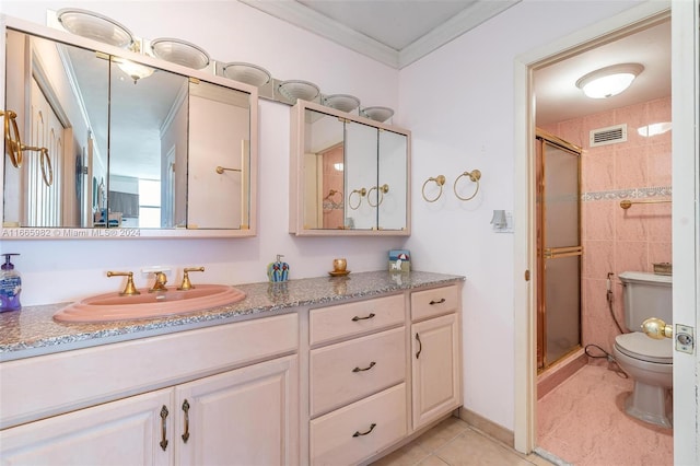 bathroom with vanity, toilet, crown molding, tile patterned flooring, and a shower with door