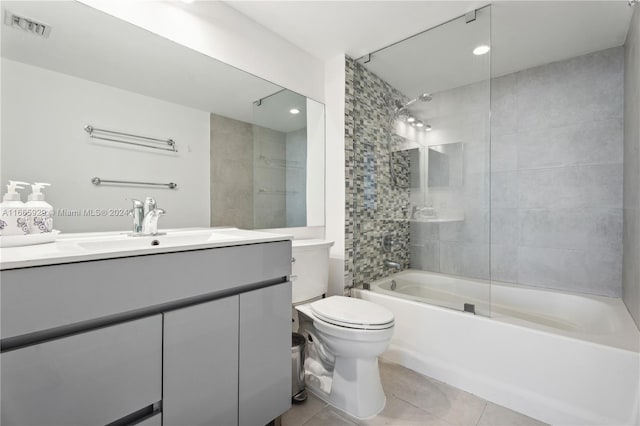 full bathroom with tiled shower / bath combo, tile patterned flooring, vanity, and toilet