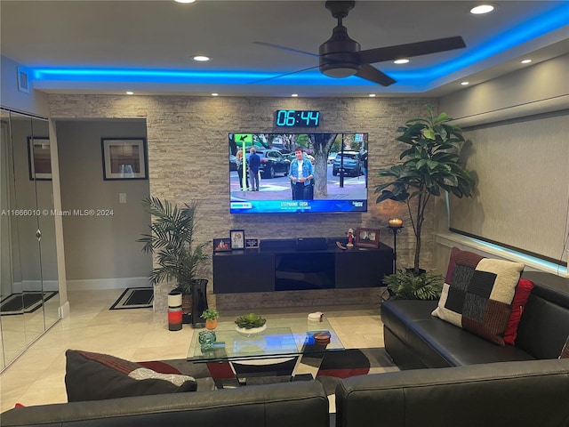 living room featuring ceiling fan and light tile patterned floors