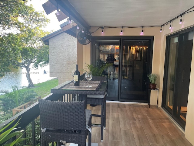 view of patio / terrace with a balcony and a water view