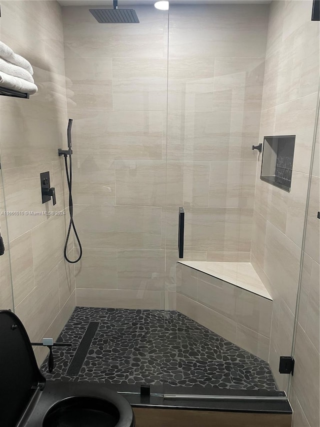 bathroom featuring a shower with door