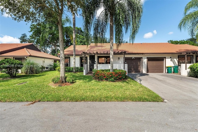 view of front of property featuring a front yard and a garage