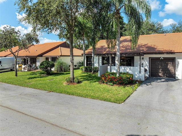 ranch-style home featuring a front yard and a garage