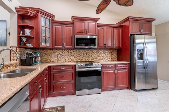 7037 Marlberry Ln, Tamarac, FL 33321 - kitchen featuring reddish brown cabinets, stainless steel appliances, and a sink