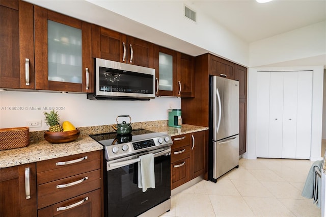 kitchen with stainless steel appliances and light stone counters