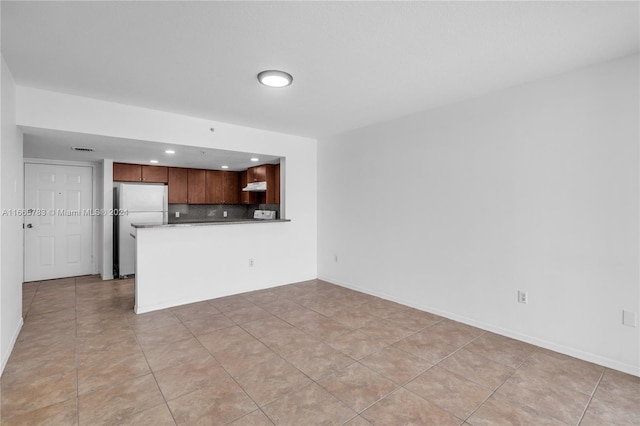 unfurnished living room featuring light tile patterned flooring