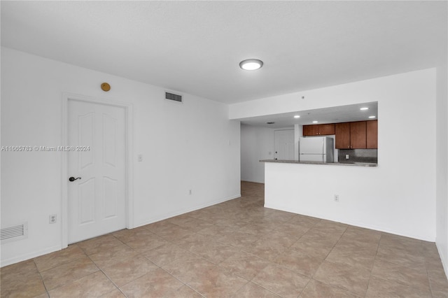 unfurnished living room featuring light tile patterned flooring