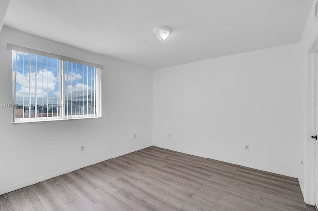 unfurnished room with light hardwood / wood-style floors