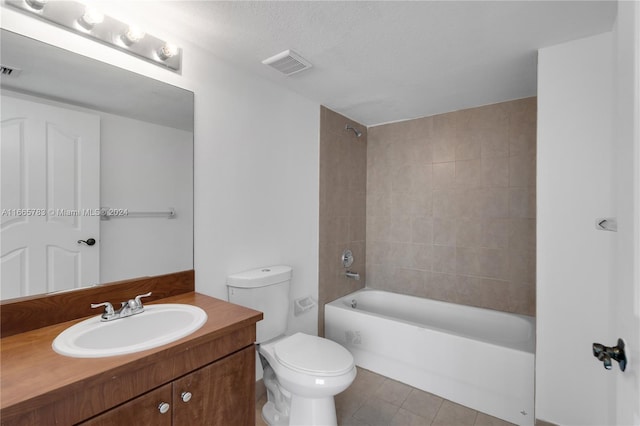 full bathroom with toilet, tiled shower / bath, vanity, and tile patterned floors